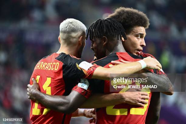 Belgium's forward Michy Batshuayi celebrates scoring the opening goal with his teammates Belgium's midfielder Axel Witsel and Belgium's midfielder...