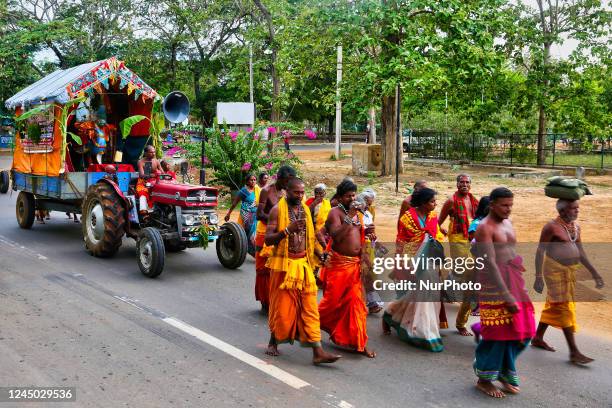 Tamil Hindu devotees walk along the road during a religious procession honouring Lord Murugan in Kilinochchi, Sri Lanka.