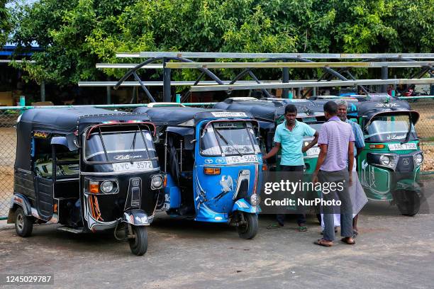 Auto drivers wait for fares along the roadside in Kilinochchi, Sri Lanka.