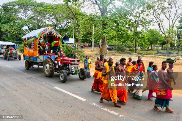 Tamil Hindu devotees walk along the road during a religious procession honouring Lord Murugan in Kilinochchi, Sri Lanka.