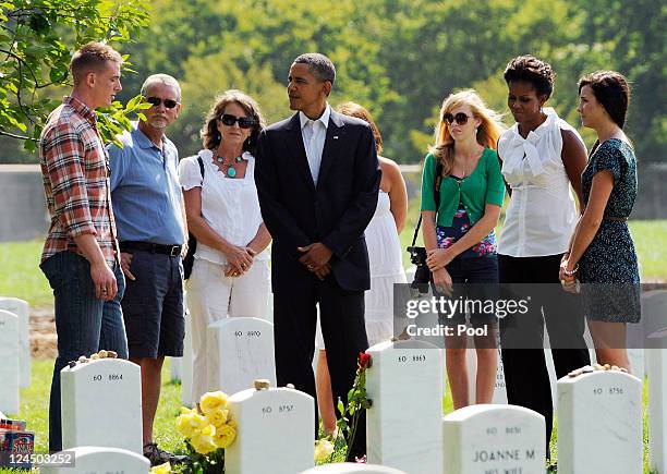 President Barack Obama and first lady Michelle Obama greet families as they visit Section 60 at Arlington National Cemetery September 10, 2011 in...