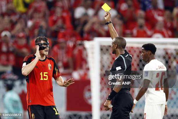 Thomas Meunier of Belgium is shown the yellow card by referee Janny Sikazwe during the FIFA World Cup Qatar 2022 group F match between Belgium and...