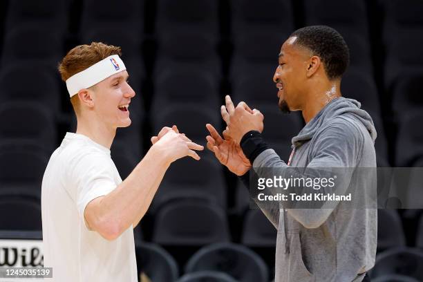 Kevin Huerter of the Sacramento Kings speaks with John Collins of the Atlanta Hawks prior to the game at State Farm Arena on November 23, 2022 in...