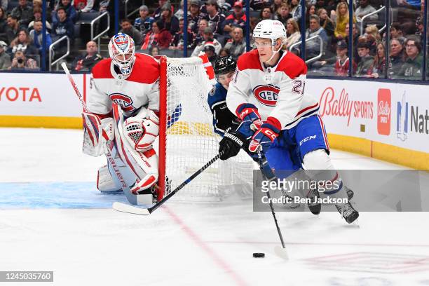 Kaiden Guhle of the Montreal Canadiens skates with the puck as Cole Sillinger of the Columbus Blue Jackets forechecks during the first period of a...