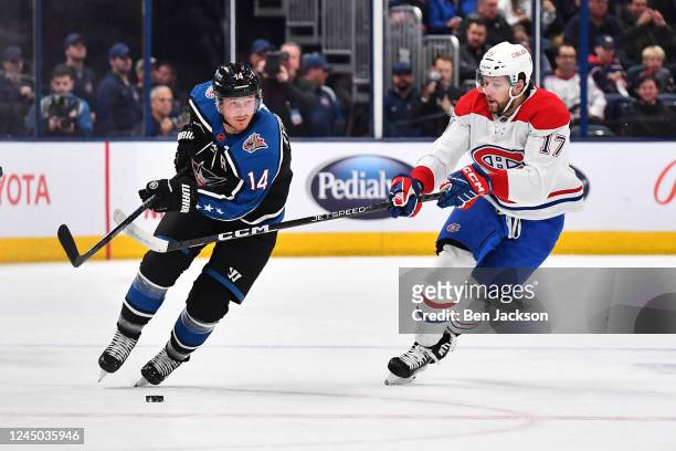 Gustav Nyquist of the Columbus Blue Jackets skates with the puck as Josh Anderson of the Montreal Canadiens defends during the first period of a game...