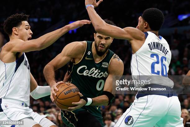 Jayson Tatum of the Boston Celtics tries to get between Spencer Dinwiddie of the Dallas Mavericks and Josh Green during the second quarter at TD...