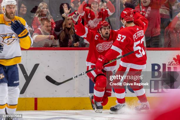 David Perron of the Detroit Red Wings congratulates teammate Dylan Larkin after he scores a goal during the second period of an NHL game against the...