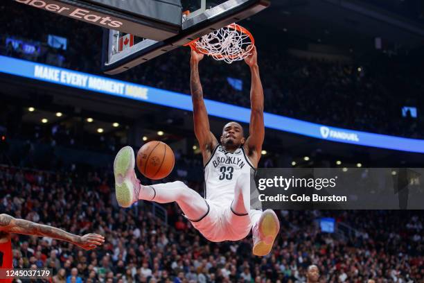 Nic Claxton of the Brooklyn Nets dunks on the net during the first half of their NBA game against the Toronto Raptors at Scotiabank Arena on November...