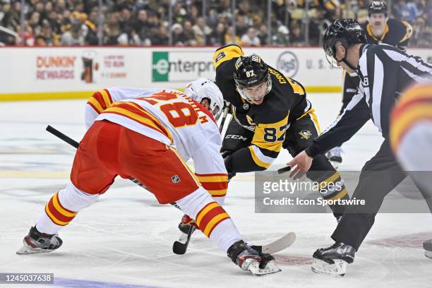 Calgary Flames Center Elias Lindholm and Pittsburgh Penguins Center Sidney Crosby face-off during the second period in the NHL game between the...