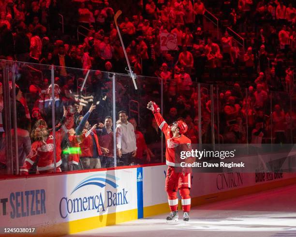 Dylan Larkin of the Detroit Red Wings throws a stick over the glass to a fan after an NHL game against the Nashville Predators at Little Caesars...