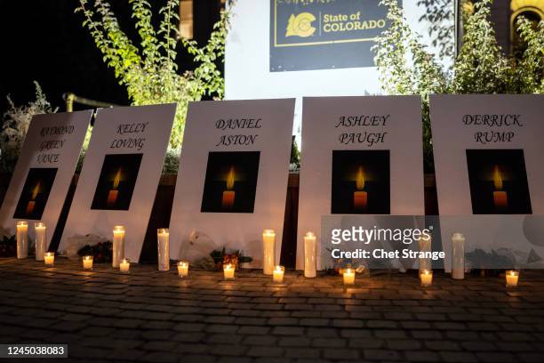 The names of the shooting victims are displayed as mourners hold a candlelight vigil outside the State Capitol building on November 23, 2022 in...