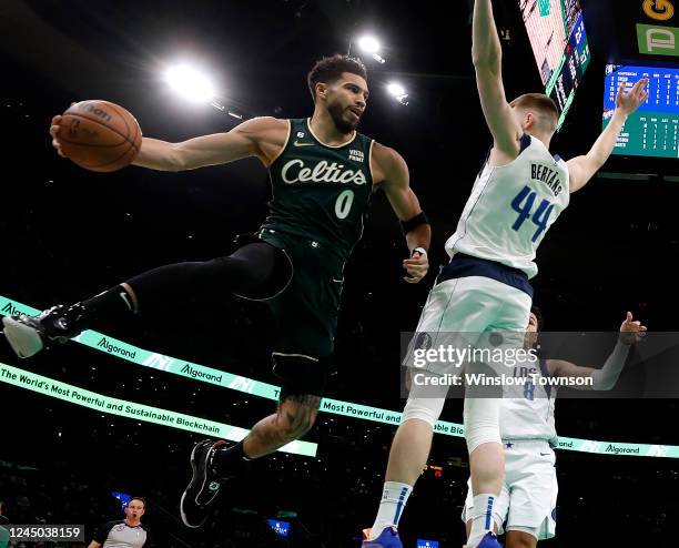 Jayson Tatum of the Boston Celtics looks to pass around Davis Bertans of the Dallas Mavericks during the second quarter at TD Garden on November 23,...