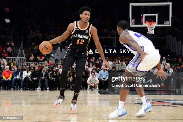 De'Andre Hunter of the Atlanta Hawks dribbles the ball during the game against the Sacramento Kings on November 23, 2022 at State Farm Arena in...