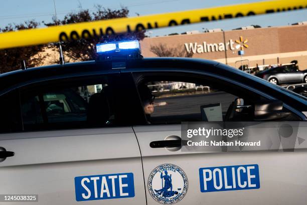 Virginia State Police officer watches the police line set up at the site of Tuesdays fatal shooting at the Chesapeake Walmart Supercenter on November...