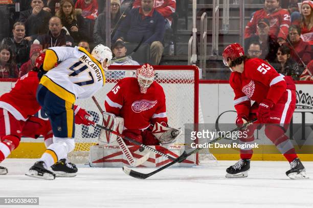 Ville Husso of the Detroit Red Wings makes a save on Michael McCarron of the Nashville Predators during the third period of an NHL game at Little...