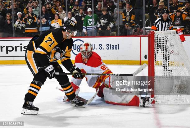 Evgeni Malkin of the Pittsburgh Penguins scores the game winning shootout goal against Dan Vladar of the Calgary Flames at PPG PAINTS Arena on...