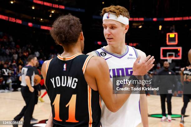 Kevin Huerter of the Sacramento Kings hugs Trae Young of the Atlanta Hawks at the conclusion of the Atlanta Hawks 115-106 victory over the Sacramento...