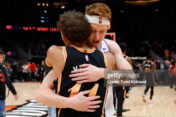 Kevin Huerter of the Sacramento Kings hugs Trae Young of the Atlanta Hawks at the conclusion of the Atlanta Hawks 115-106 victory over the Sacramento...