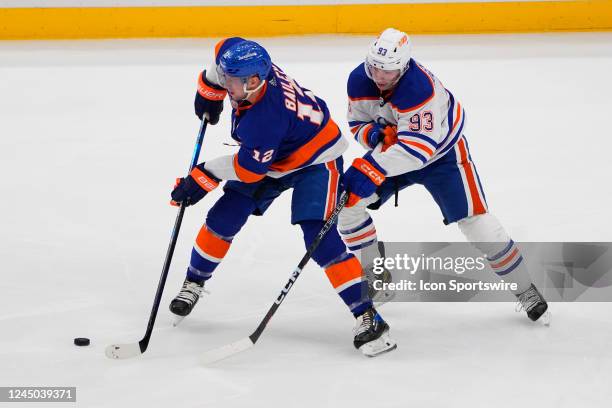 New York Islanders Right Wing Josh Bailey and Edmonton Oilers Left Wing Ryan Nugent-Hopkins battle for the puck during the third period of the...