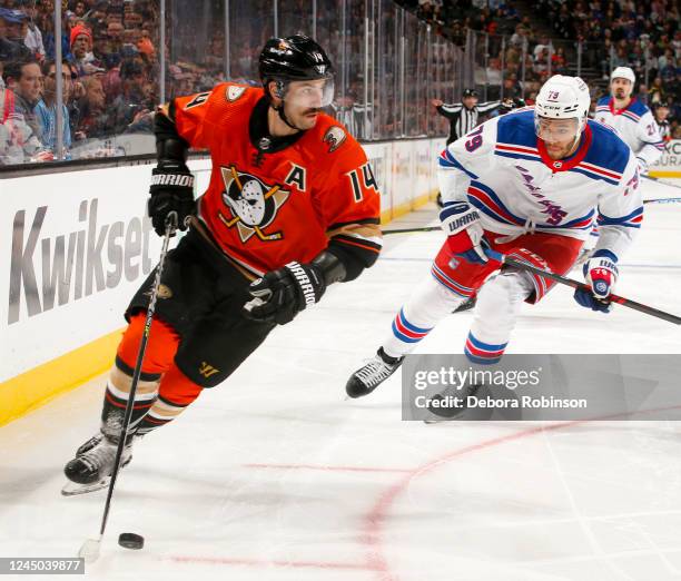 Adam Henrique of the Anaheim Ducks skates with the puck with pressure from K'Andre Miller of the New York Rangers during the third period at Honda...
