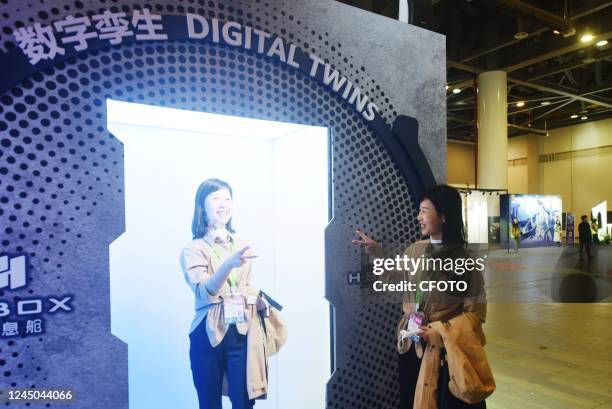 Visitors interact with the "self" using digital twin technology at the Metaverse exhibition area of the China International Cartoon and Animation...