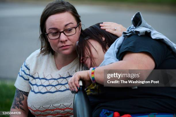 Carissa Schnable, left, comforts her sister Bethany Rohrer during a vigil for Rohrer's son Lawrence Morgan on June 22 in Parma, Ohio. Morgan was shot...