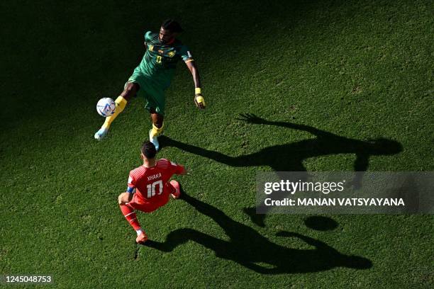 Cameroon's midfielder Andre-Frank Zambo Anguissa fights for the ball with Switzerland's midfielder Granit Xhaka during the Qatar 2022 World Cup Group...