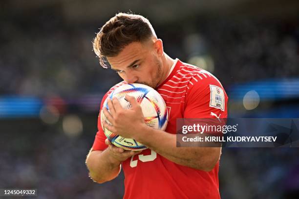 Switzerland's midfielder Xherdan Shaqiri kisses the ball during the Qatar 2022 World Cup Group G football match between Switzerland and Cameroon at...