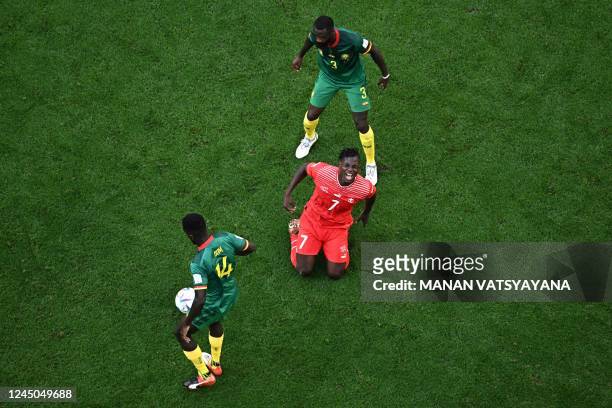 Switzerland's forward Breel Embolo reacts on the pitch after he fought for the ball with Cameroon's midfielder Samuel Gouet and Cameroon's defender...