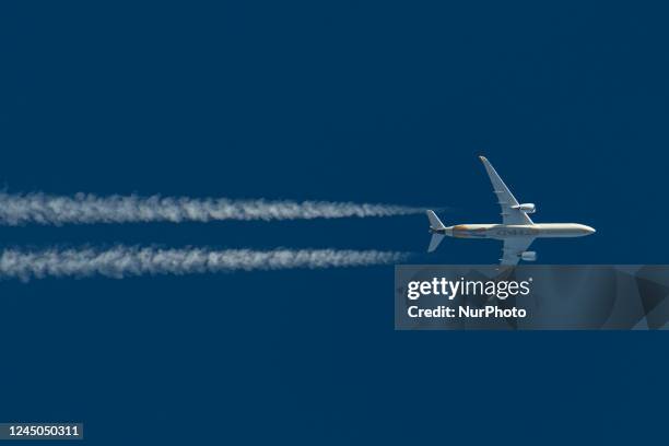 Etihad Airways modern Airbus A350 passenger aircraft as seen flying in the blue sky over the Netherlands in Europe, the route EY12 from London...