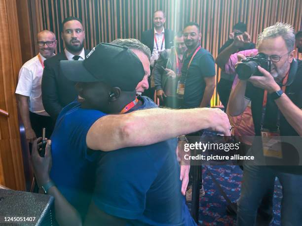 November 2022, Qatar, Doha: Louis van Gaal , national soccer coach of the Netherlands, hugs journalist Papa Gueye from Senegal after a press...