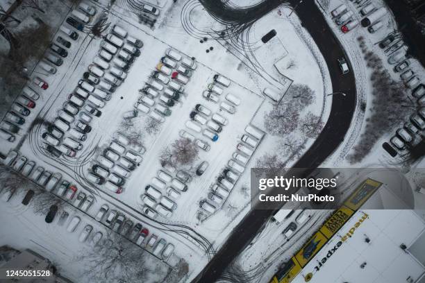 Cars covered in snow are seen in Warsaw, Poland on 24 November, 2022.