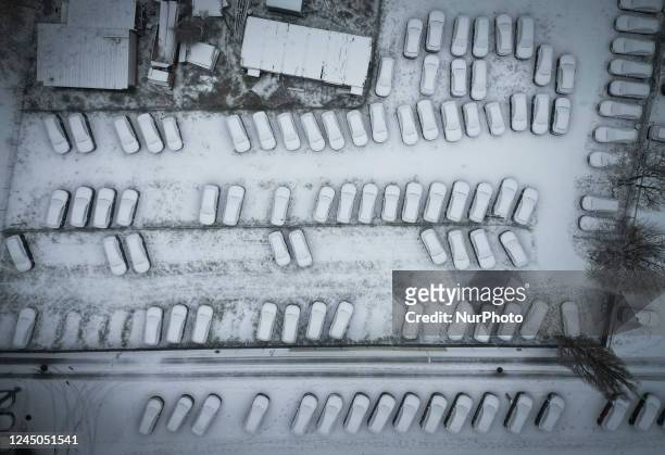 Snow covered cars are seen parked at a car dealership in Warsaw, Poland on 24 November, 2022.