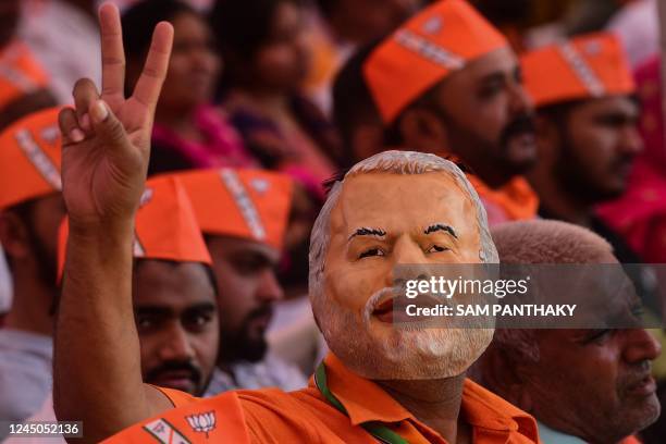 Supporters of India's Bhartiya Janata Party cheer during a rally to be addressed by Indias prime minister Narendra Modi ahead of Gujarat state...