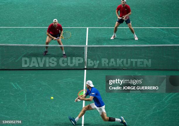 Italys Simone Bolelli returns the ball to US Tommy Paul and Jack Sock during the men's double quarter-final tennis match between Italy and United...
