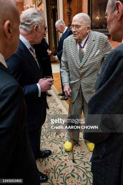 Britain's King Charles III talks with artist David Hockney during a luncheon for Members of the Order of Merit, at Buckingham Palace in London on...