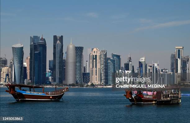 Traditional Qatari wooden Dhow boats are anchored in front of Doha's skyscrapers on November 24 as the country hosts the 2022 FIFA World Cup football...