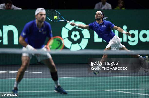 Italys Fabio Fognini and his teammate Italys Simone Bolelli returns the ball to US Tommy Paul and US Jack Sock during the men's double quarter-final...