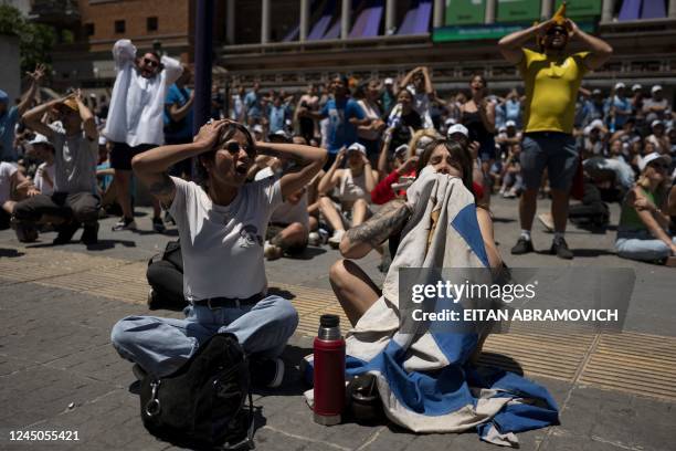 Uruguayan football fans react while watching the broadcast of the Qatar 2022 World Cup Group H football match between Uruguay and South Korea in...