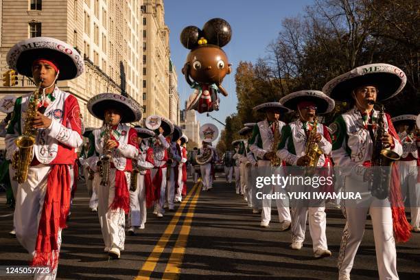 Mexico marching band leads the Ada Twist, Scientist balloon during the 96th Annual Macy's Thanksgiving Day Parade in New York City on November 24,...