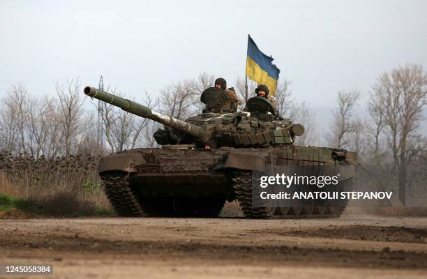 Ukrainian servicemen ride a tank on a road in eastern Ukraine on November 24 amid the Russian invasion of Ukraine.