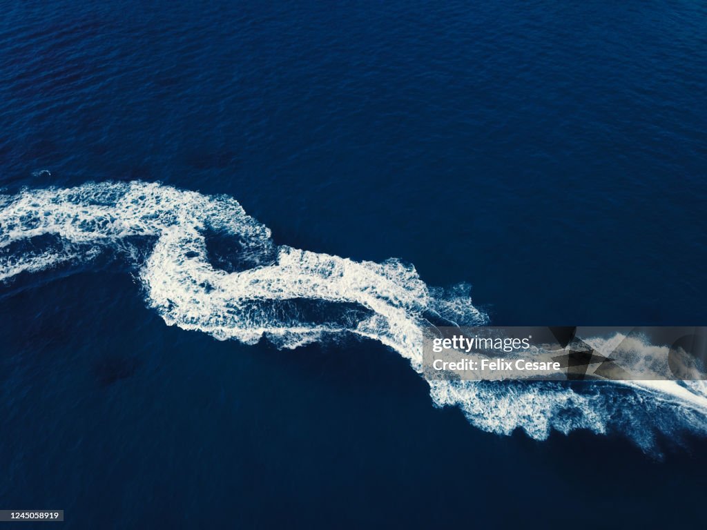 Boat wake from above. High contrast abstract background.