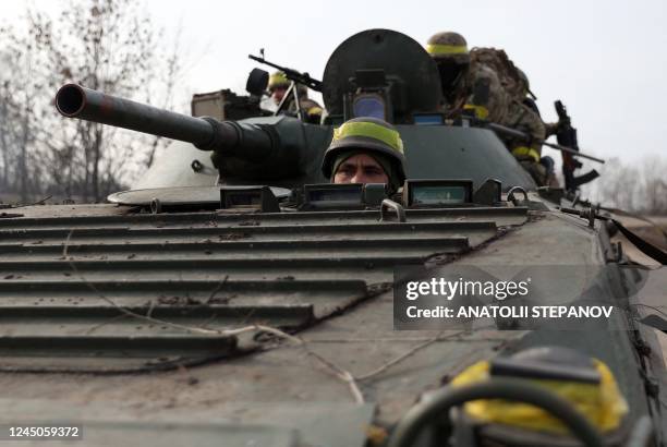 Ukrainian servicemen ride an infantry fighting vehicle towards a frontline in eastern Ukraine on November 24 amid the Russian invasion of Ukraine.