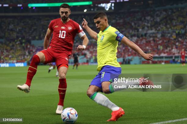 Serbia's forward Dusan Tadic fights for the ball with Brazil's defender Thiago Silva during the Qatar 2022 World Cup Group G football match between...