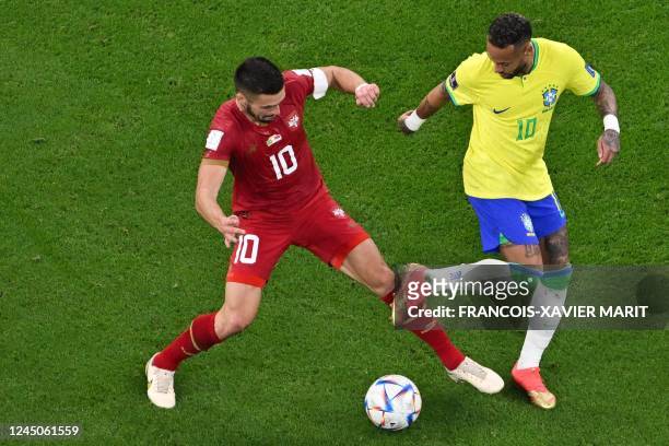 Brazil's forward Neymar and Serbia's forward Dusan Tadic fight for the ball during the Qatar 2022 World Cup Group G football match between Brazil and...