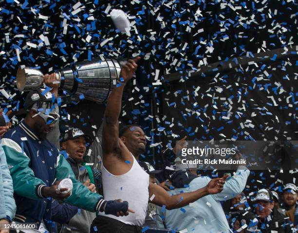 Argos DB and MVP Henoc Muamba, in undershirt, celebrates as a teammate hoists the Cup. Toronto Argonauts hold a Grey Cup rally at Maple Leaf Square...