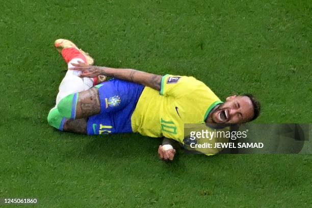 Brazil's forward Neymar gestures on the ground during the Qatar 2022 World Cup Group G football match between Brazil and Serbia at the Lusail Stadium...