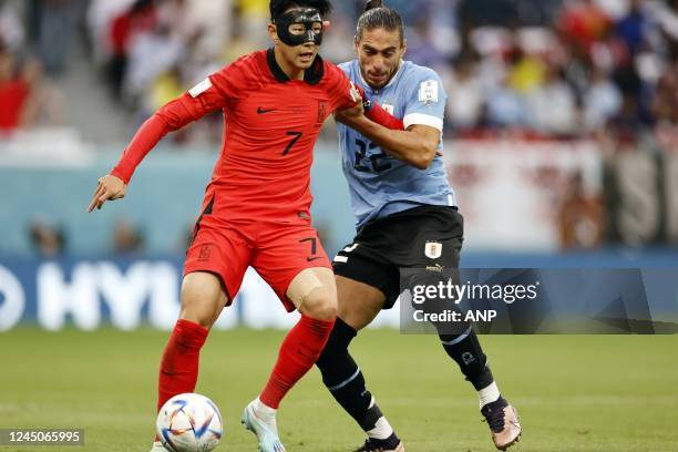 Heung-min Son of Korea Republic, Martin Caceres of Uruguay during the FIFA World Cup Qatar 2022 group H match between Uruguay and South Korea at...