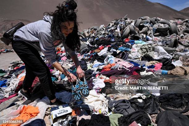 Lawyer Paulina Silva shows clothes dumped in the desert, in La Pampa sector of Alto Hospicio, about 10 km east of the city of Iquique, Chile, on...