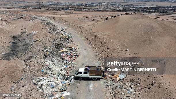 Truck dumps rubbish in a clandestine roadside dump on the outskirts of the town of Alto Hospicio, Iquique, Chile on November 11, 2022. - Hills of...